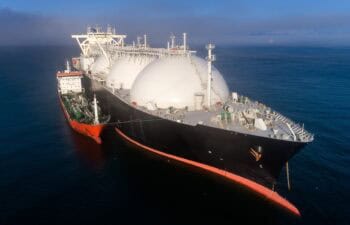 A small tanker on the roadstead bunkers a large LNG tanker.