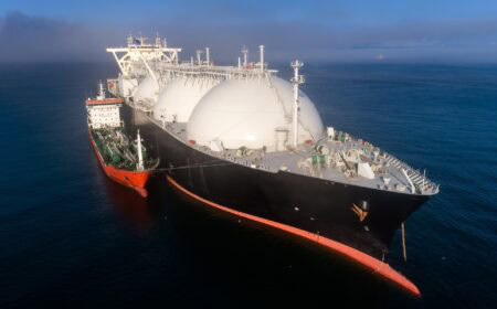A small tanker on the roadstead bunkers a large LNG tanker.