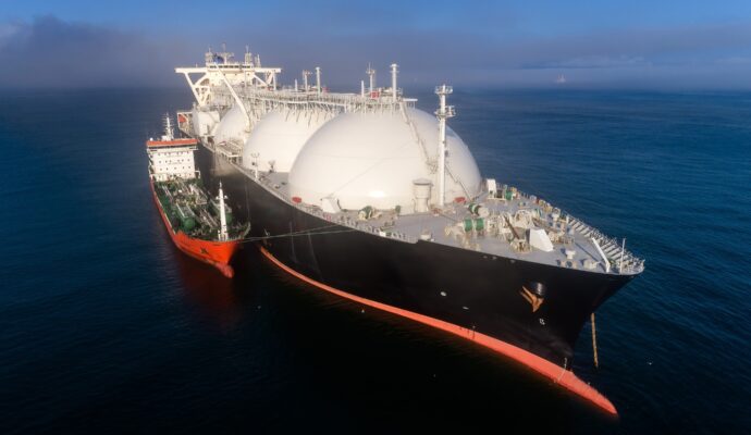 A small tanker on the roadstead bunkers a large LNG tanker.
