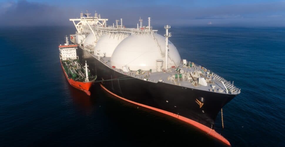 A small tanker on the roadstead bunkers a large LNG tanker.